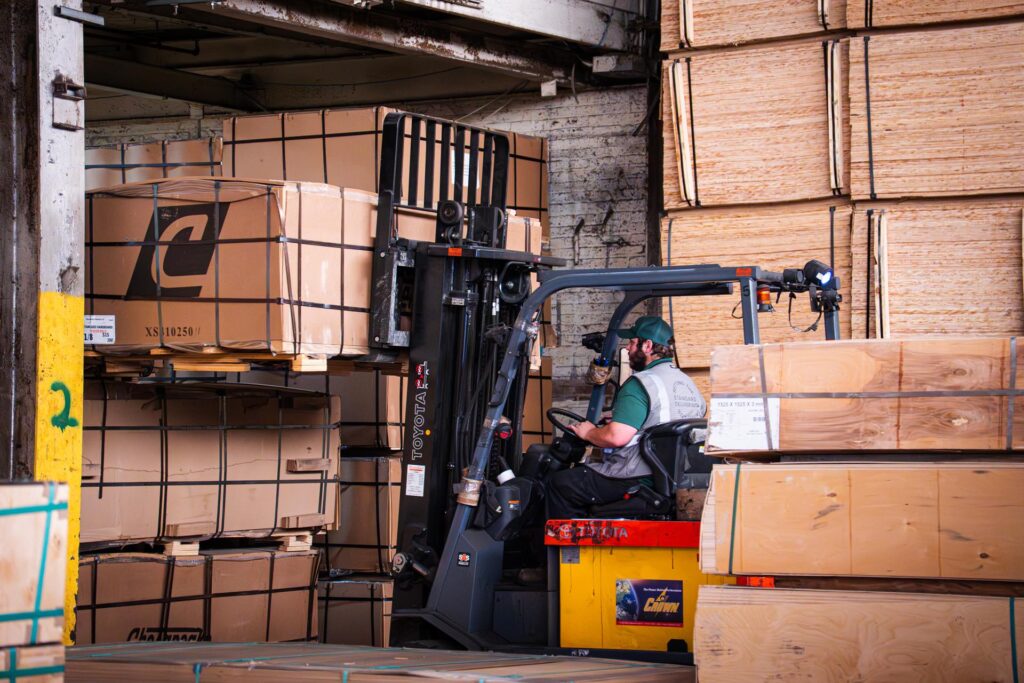 forklift driver in wood warehouse